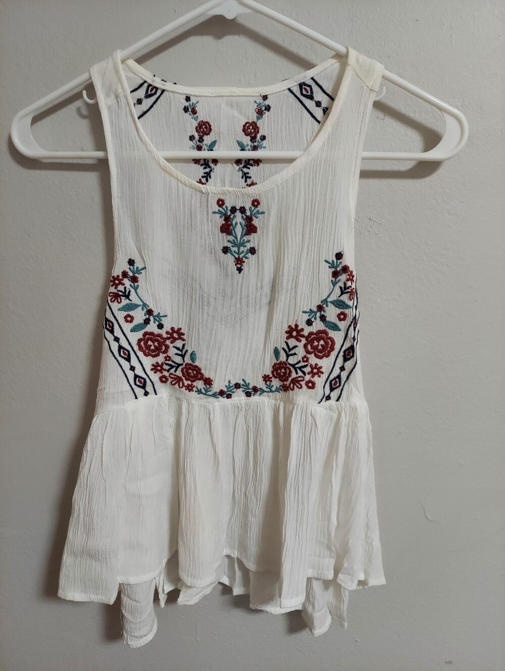 Embroidered White Sleeveless Peplum Top